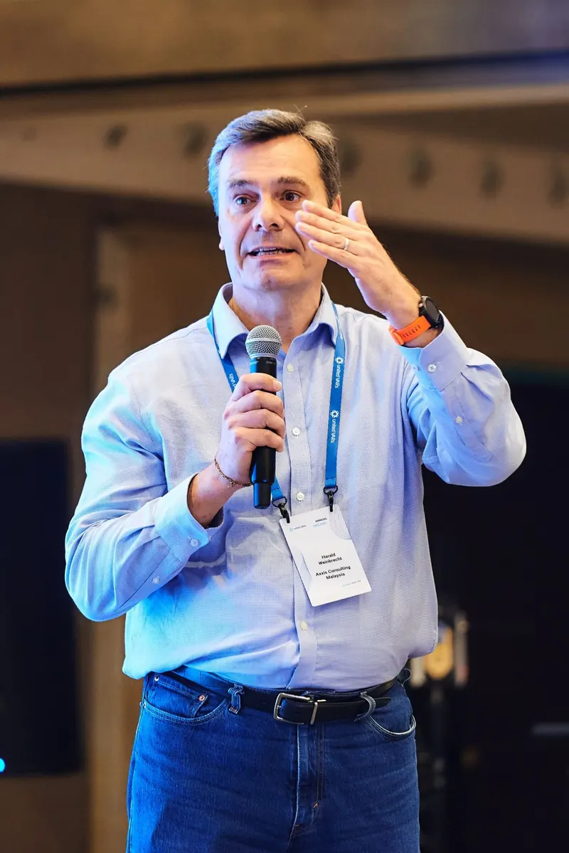 Harald Weinbrecht speaking with a microphone at the United VARs annual meeting